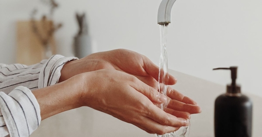 woman with hands in water